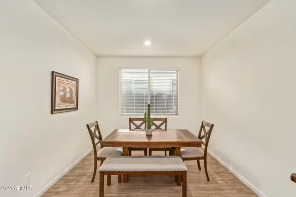 a view of a dining room with furniture and wooden floor