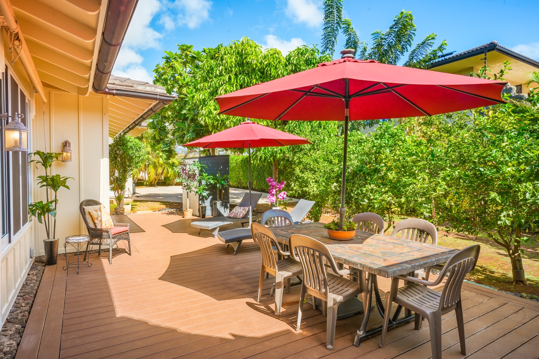 1730 Keleka Road Koloa, HI 96756 - Photo 5 of 29 a view of a patio with chairs and table under an umbrella