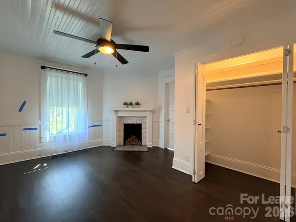 a kitchen with stainless steel appliances granite countertop a sink a stove cabinets counter space and a window