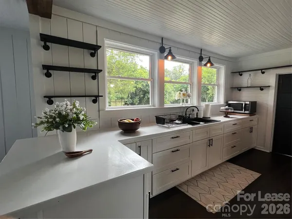 a kitchen with stove and cabinets