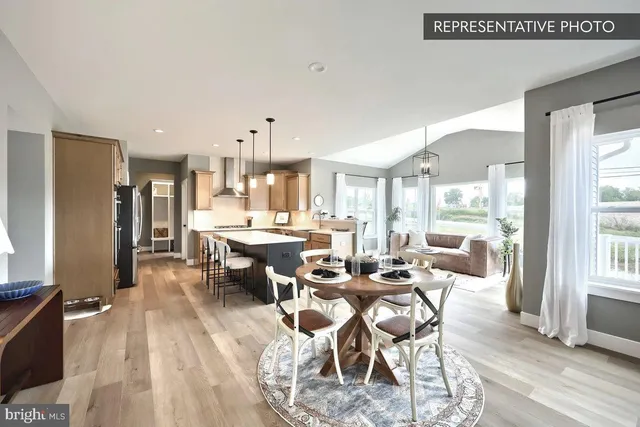 a kitchen with a dining table and chairs