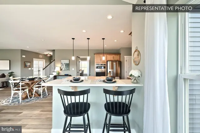 a kitchen with stainless steel appliances a stove a refrigerator and cabinets
