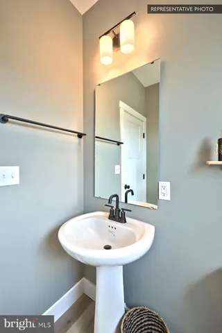 a bathroom with a sink a toilet and shower curtain