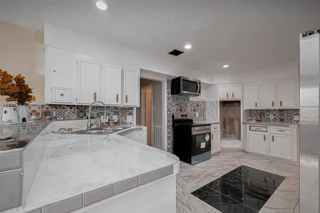 a kitchen with a stove and cabinets