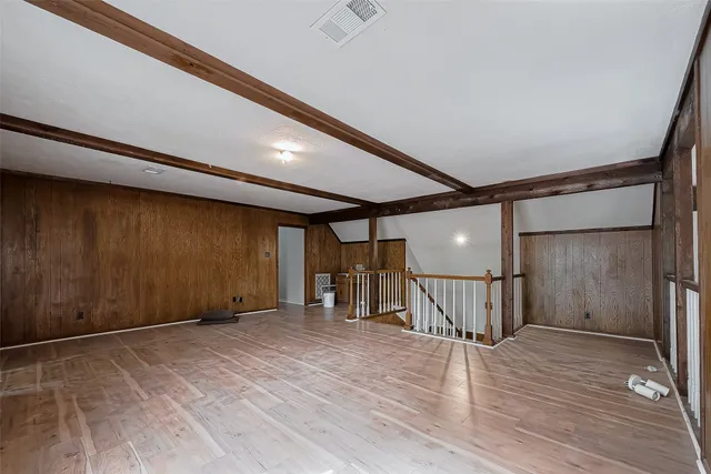 a view of a room with a wooden floor and a window