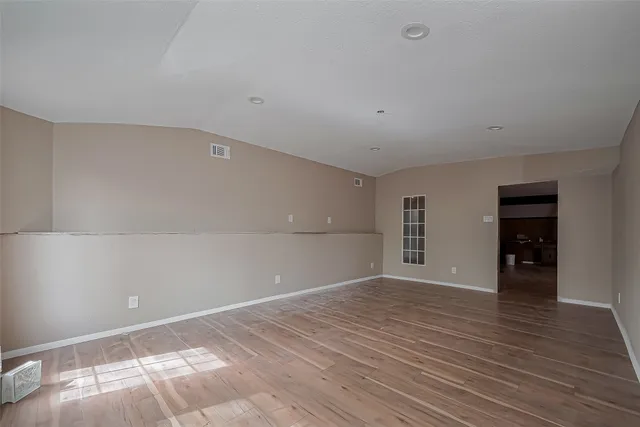 a view of room with wooden floor and window