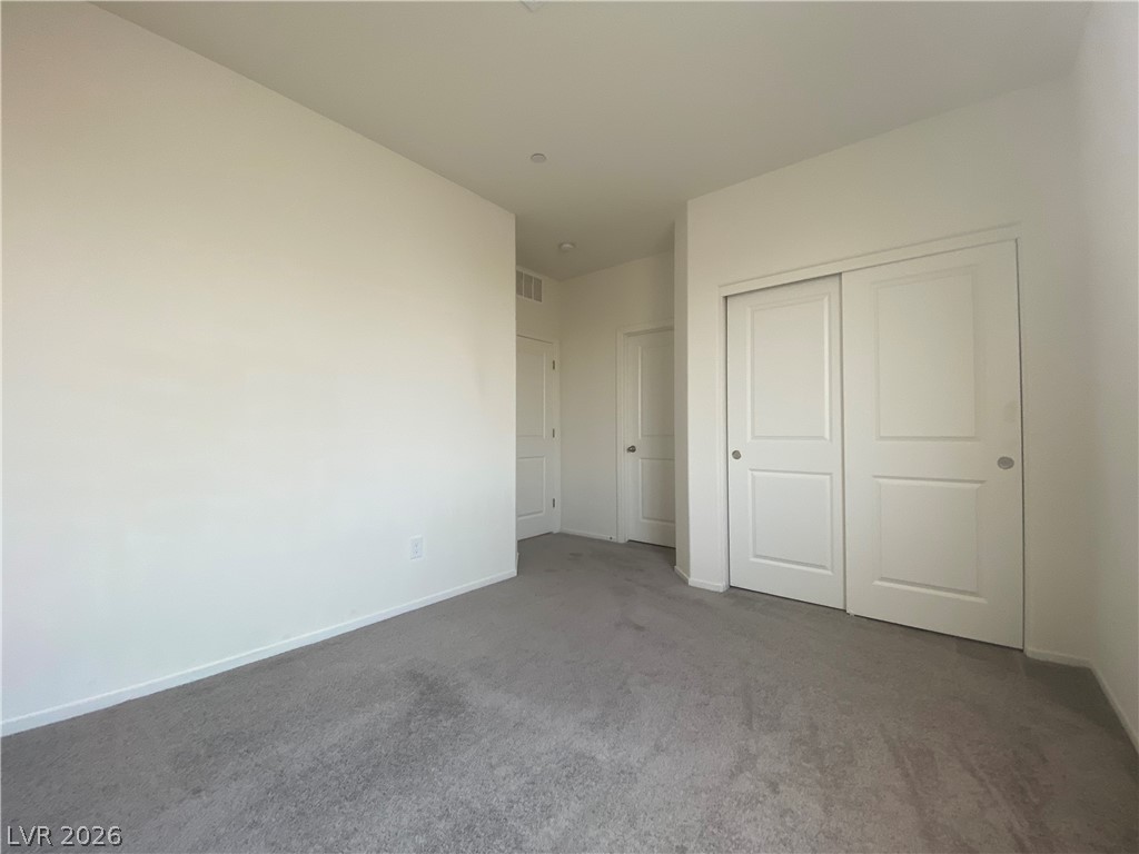 436 Cadence View Way Henderson, NV 89011 - Photo 21 of 36 A spacious, naturally illuminated room features plush carpeting and convenient sliding closet doors.