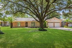 1539 Maux Drive Houston, TX 77043 - Photo 2 of 20 a front view of a house with a garden and trees