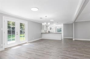 1539 Maux Drive Houston, TX 77043 - Photo 7 of 20 an empty room with wooden floor and windows