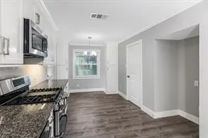 a kitchen with a stove and a refrigerator