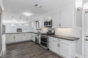 1539 Maux Drive Houston, TX 77043 - Photo 10 of 20 a kitchen with granite countertop white cabinets and white appliances