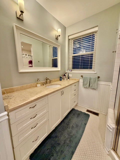 Undisclosed Address Chicago, IL 60614 - Photo 10 of 18 a bathroom with a double vanity sink a mirror and a bathtub