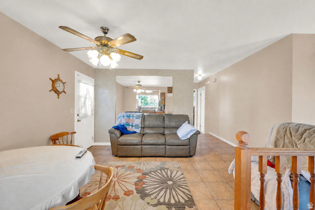 8029 Angel Street Sandy, UT 84070 - Photo 7 of 21 Spacious living area featuring tile flooring, neutral wall tones, and a ceiling fan with integrated lighting
