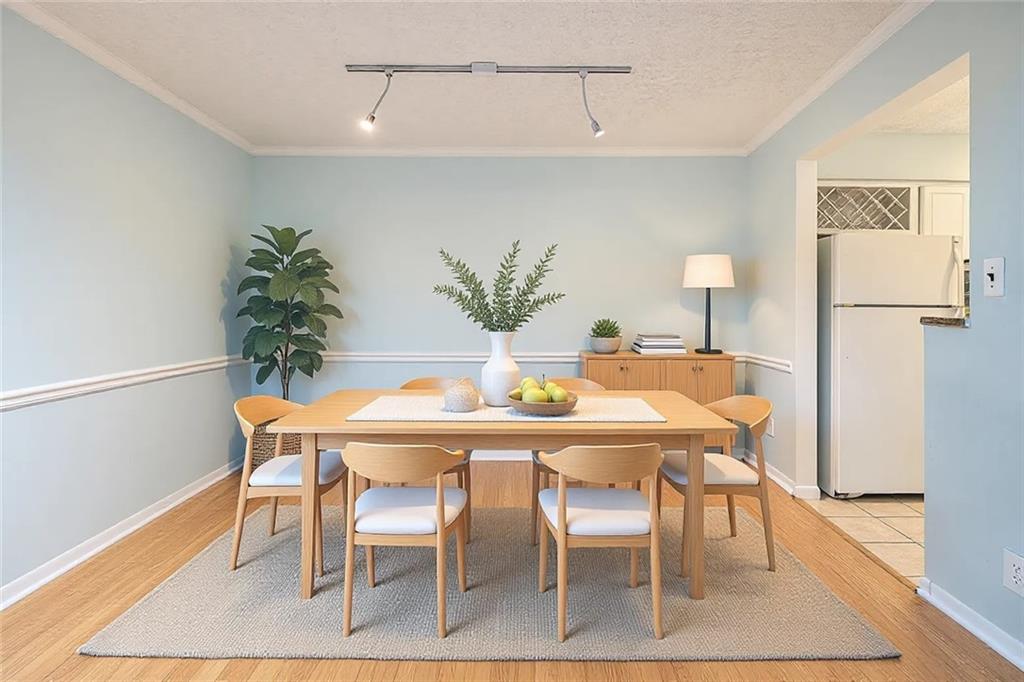 5143 Roswell Road, Unit 8 Atlanta, GA 30342 - Photo 12 of 27 a dining room with furniture and wooden floor