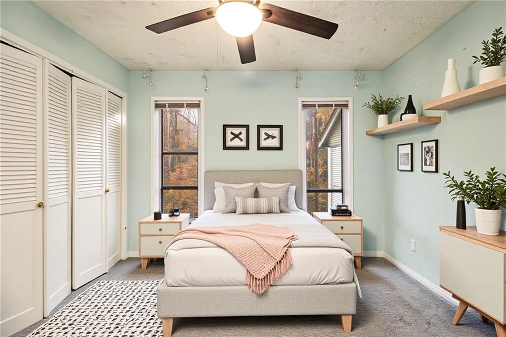 5143 Roswell Road, Unit 8 Atlanta, GA 30342 - Photo 18 of 27 a bedroom with a large bed and a chandelier