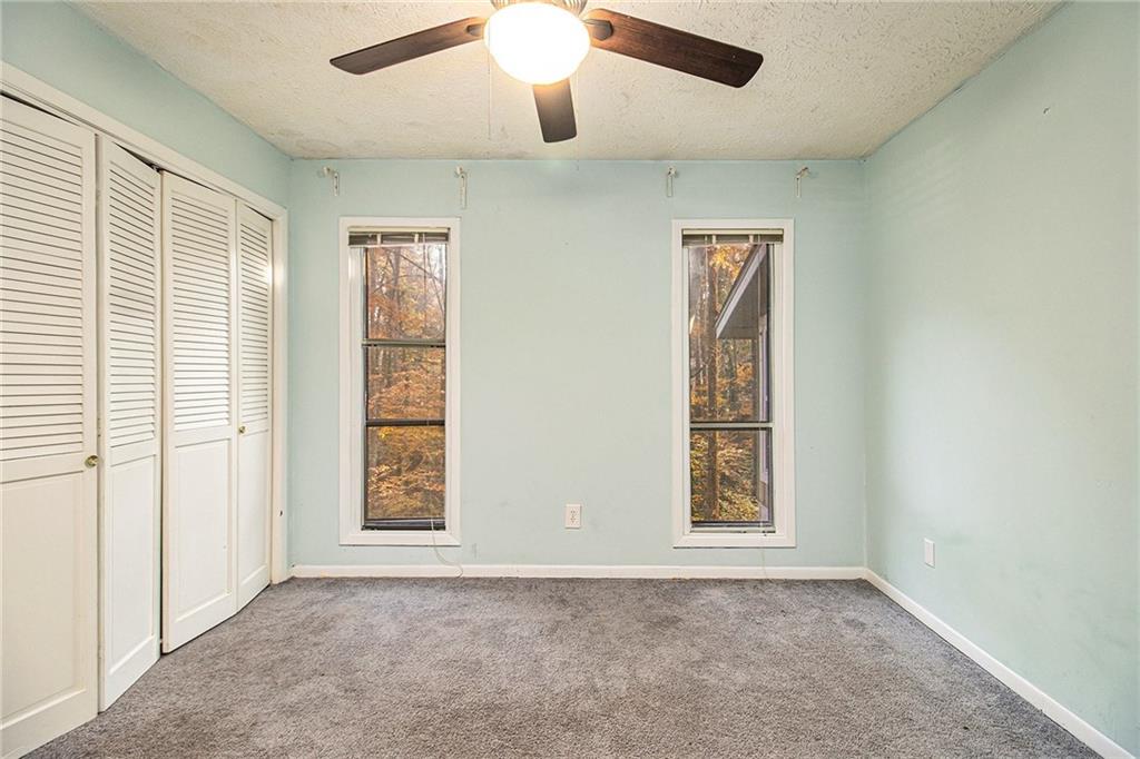 5143 Roswell Road, Unit 8 Atlanta, GA 30342 - Photo 19 of 27 an empty room with windows and ceiling fan