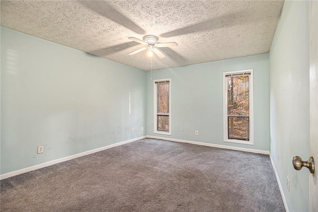 5143 Roswell Road, Unit 8 Atlanta, GA 30342 - Photo 22 of 27 an empty room with windows and fan