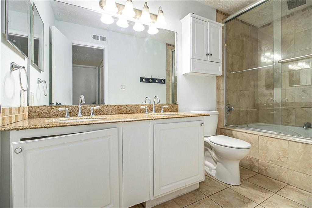 5143 Roswell Road, Unit 8 Atlanta, GA 30342 - Photo 26 of 27 a bathroom with a sink toilet and shower