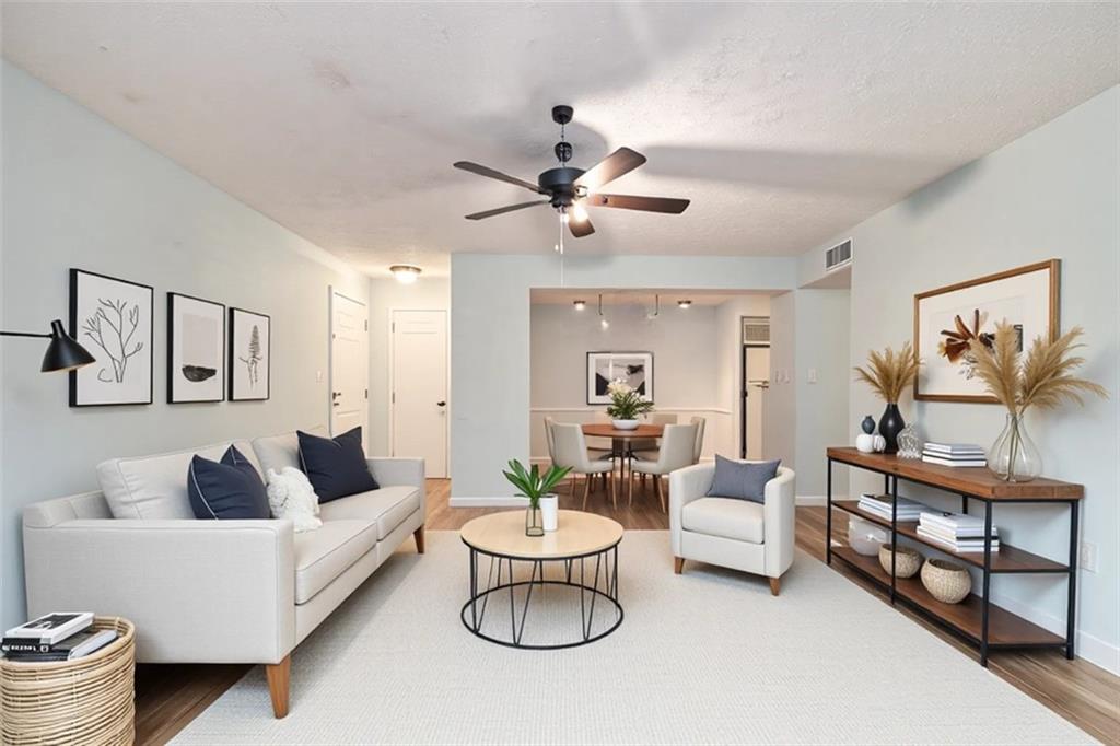 5143 Roswell Road, Unit 8 Atlanta, GA 30342 - Photo 5 of 27 a living room with furniture and a painting on the wall