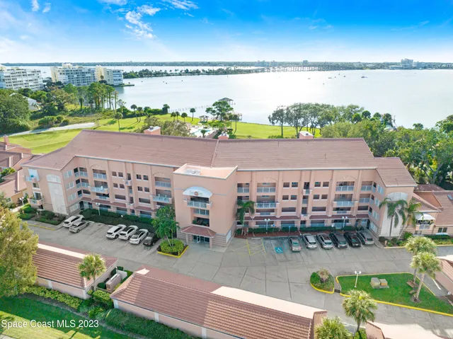 an aerial view of a house with a garden and outdoor seating
