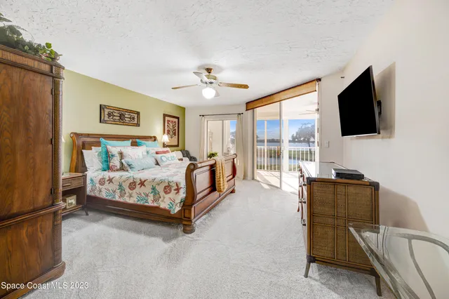 a bedroom with a large bed and a flat screen tv