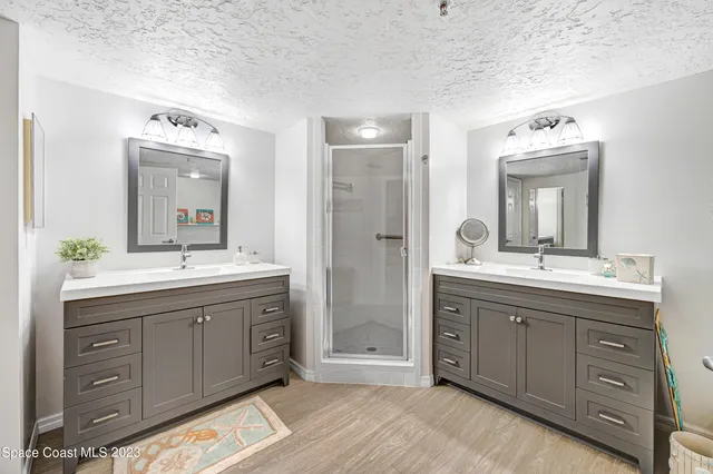 a spacious bathroom with a double vanity sink double and mirror