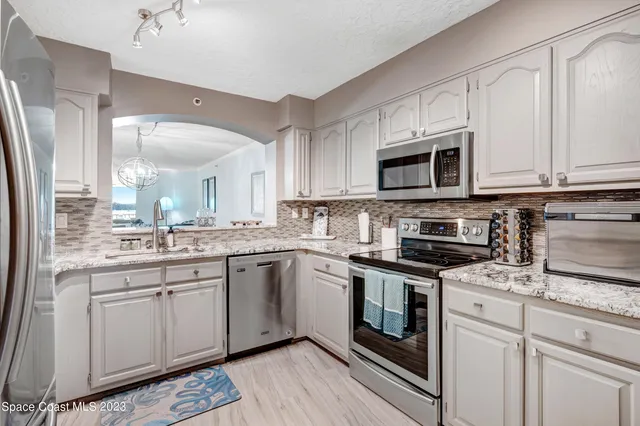 a kitchen with stainless steel appliances granite countertop a sink and cabinets