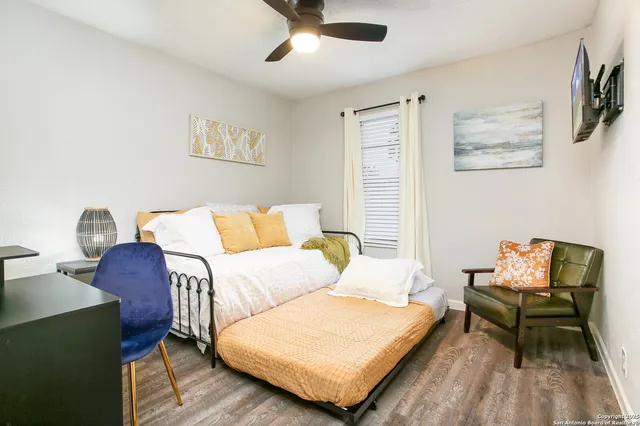 a bedroom with a bed and wooden floor