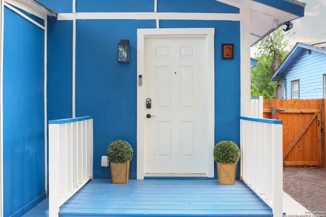 a living room with furniture and kitchen area