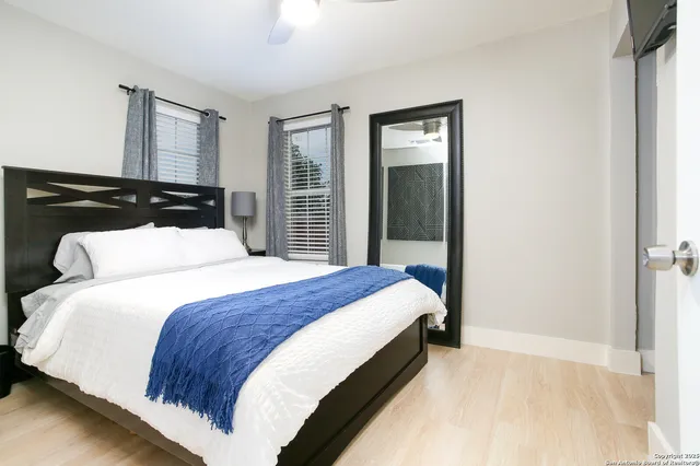 a kitchen with a refrigerator a sink dishwasher and a stove with wooden floor