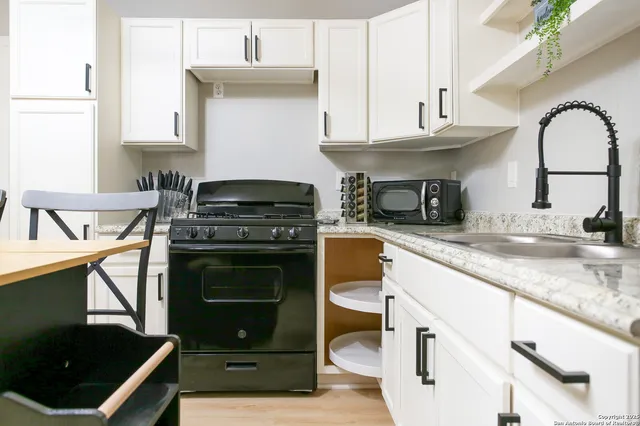 a stove top oven sitting inside of a kitchen