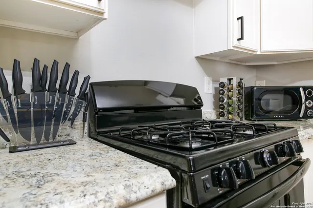 a kitchen with a stove and a refrigerator
