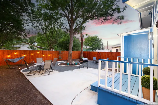 a view of a backyard with table and chairs