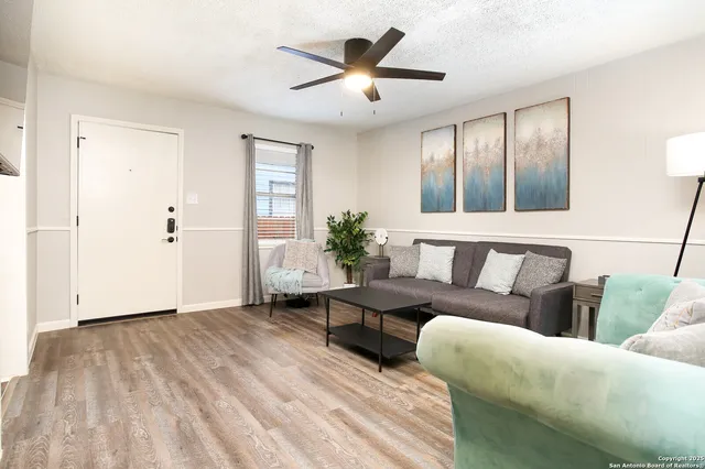 a living room with furniture and wooden floor