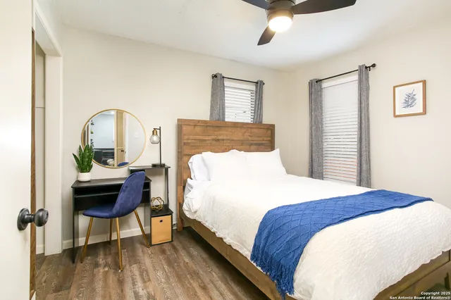 a bedroom with a bed a dresser and chair