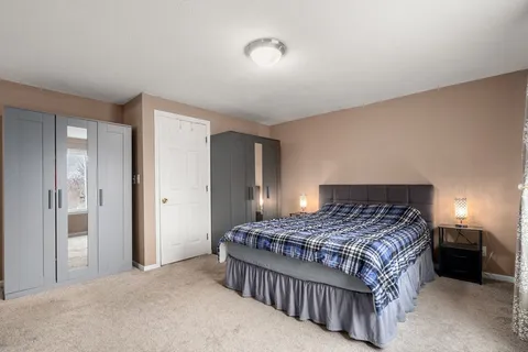 a bedroom with a bed and a lamp