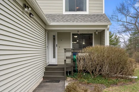 a view of a house with plants and wooden floor