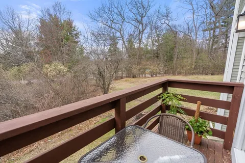 a view of balcony with wooden floor and fence