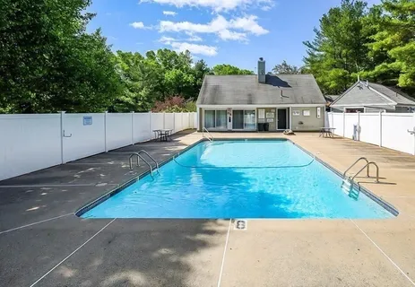 swimming pool view with a seating space