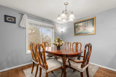 a dining room with furniture and chandelier