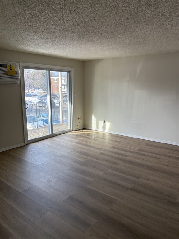 80 Damon Road, Unit 8201 Northampton, MA 01060 - Photo 2 of 19 a view of an empty room with wooden floor and a window