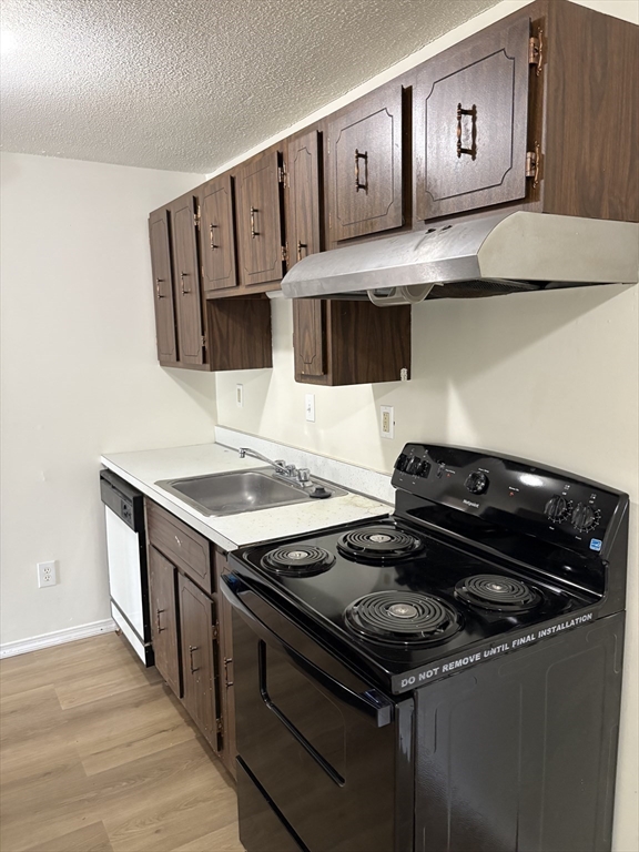 80 Damon Road, Unit 8201 Northampton, MA 01060 - Photo 5 of 19 a kitchen with stainless steel appliances a stove and a microwave