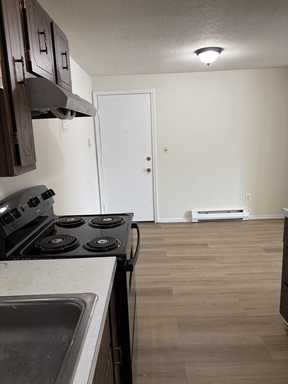80 Damon Road, Unit 8201 Northampton, MA 01060 - Photo 7 of 19 a kitchen with a stove and a refrigerator