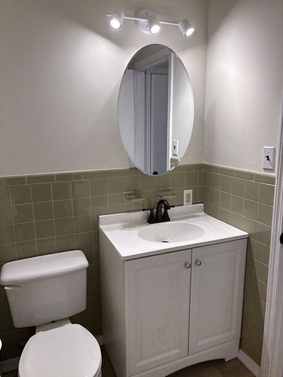 80 Damon Road, Unit 8201 Northampton, MA 01060 - Photo 9 of 19 a bathroom with a toilet sink and mirror