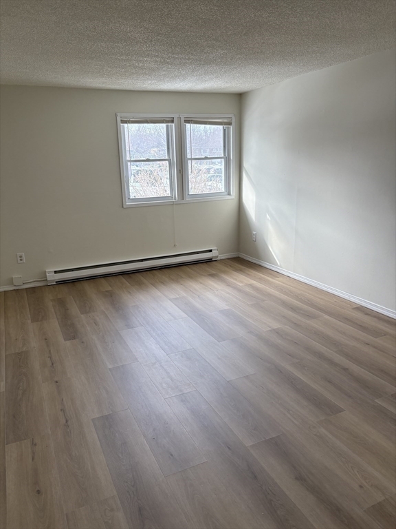 80 Damon Road, Unit 8201 Northampton, MA 01060 - Photo 10 of 19 an empty room with wooden floor and windows