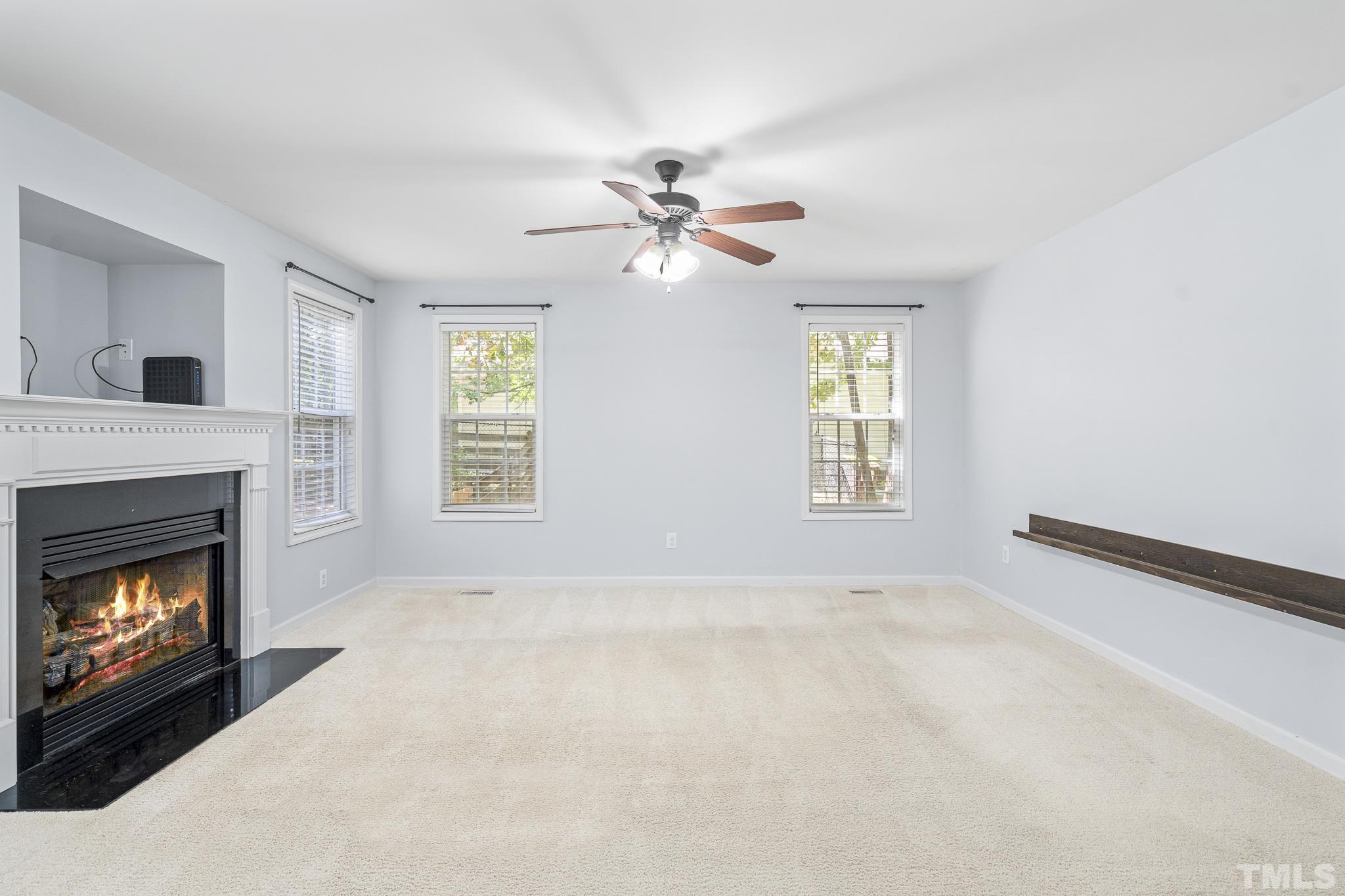 130 Broken Lance Drive Youngsville, NC 27596 - Photo 13 of 32 a living room with furniture and a fireplace