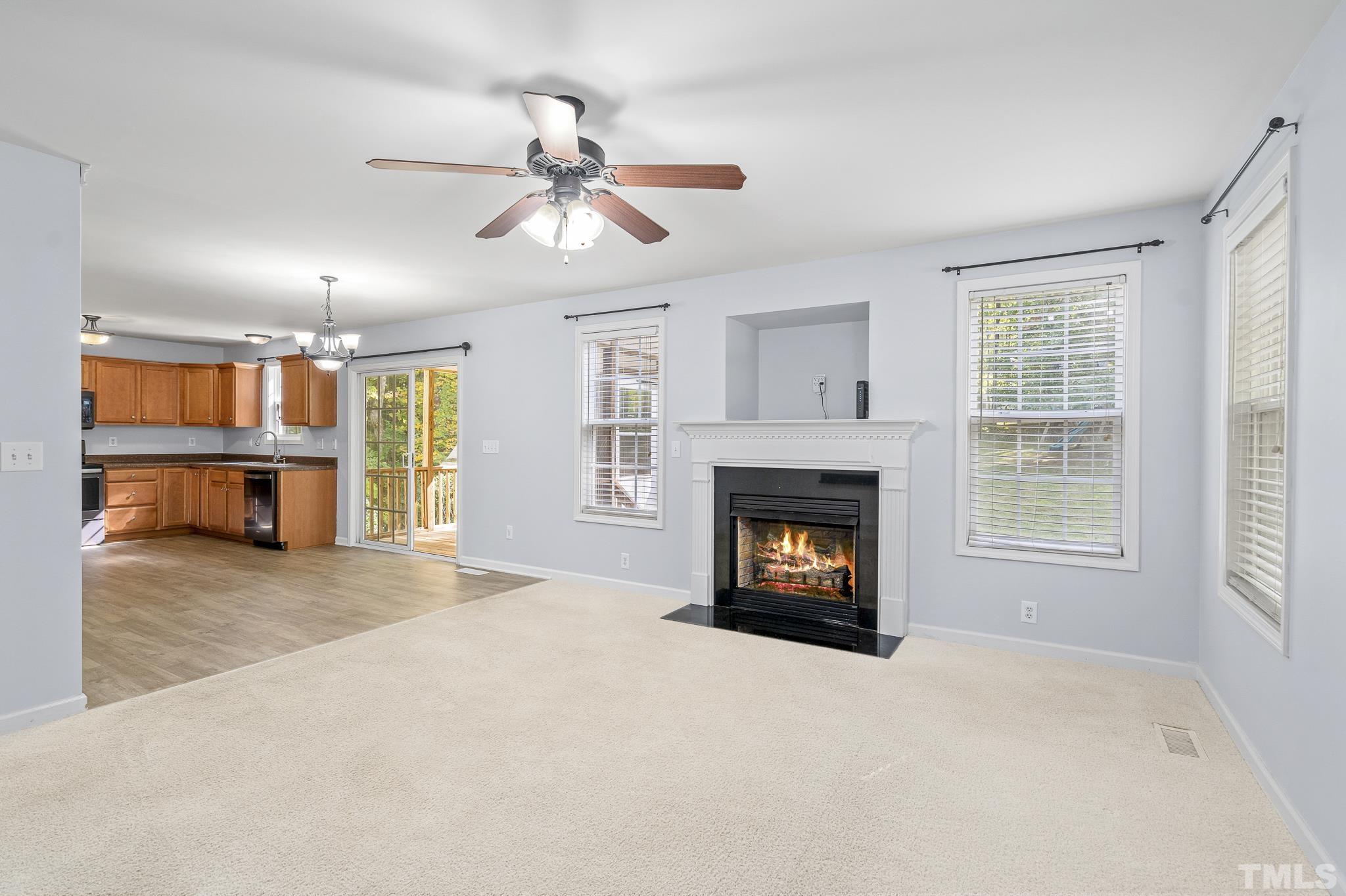 130 Broken Lance Drive Youngsville, NC 27596 - Photo 14 of 32 a view of an empty room with window and fire place