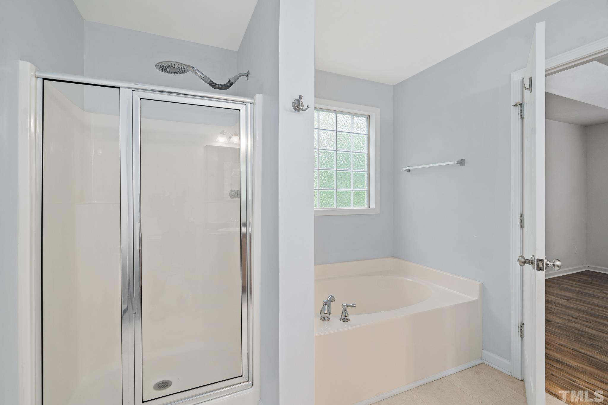 130 Broken Lance Drive Youngsville, NC 27596 - Photo 20 of 32 a bathroom with a bathtub and a shower