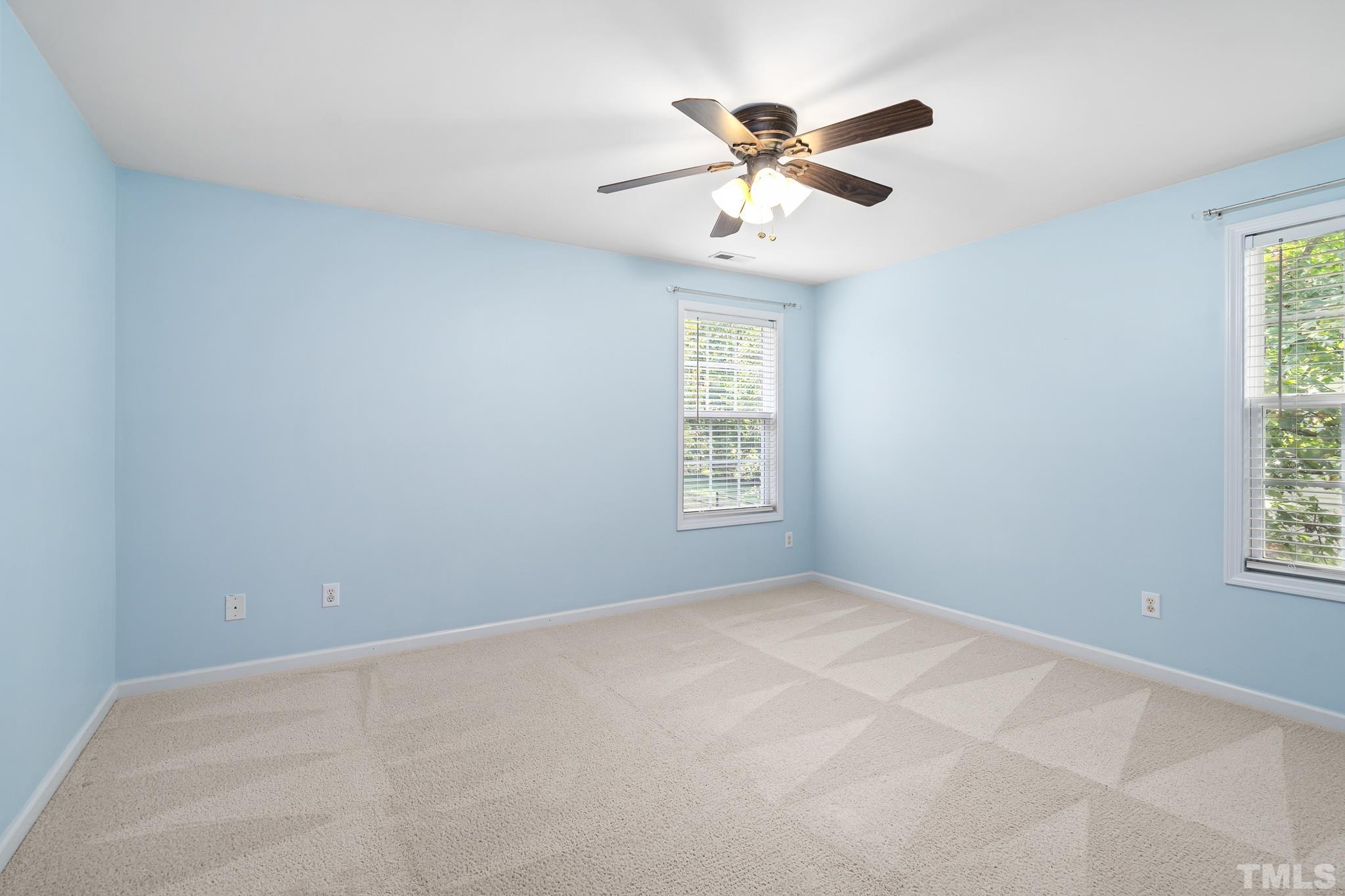130 Broken Lance Drive Youngsville, NC 27596 - Photo 22 of 32 an empty room with windows and fan