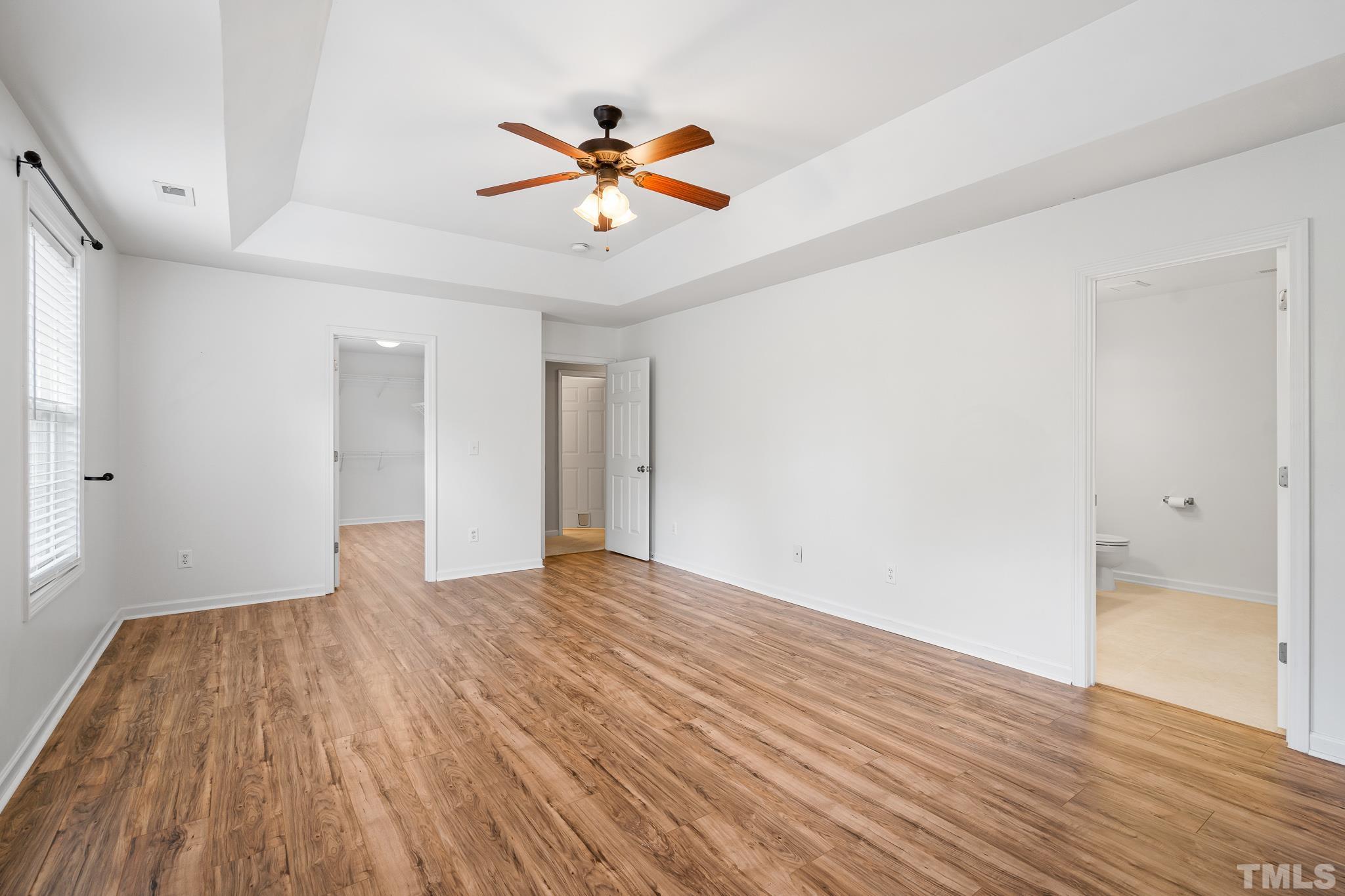 130 Broken Lance Drive Youngsville, NC 27596 - Photo 26 of 32 a view of empty room with wooden floor and fan